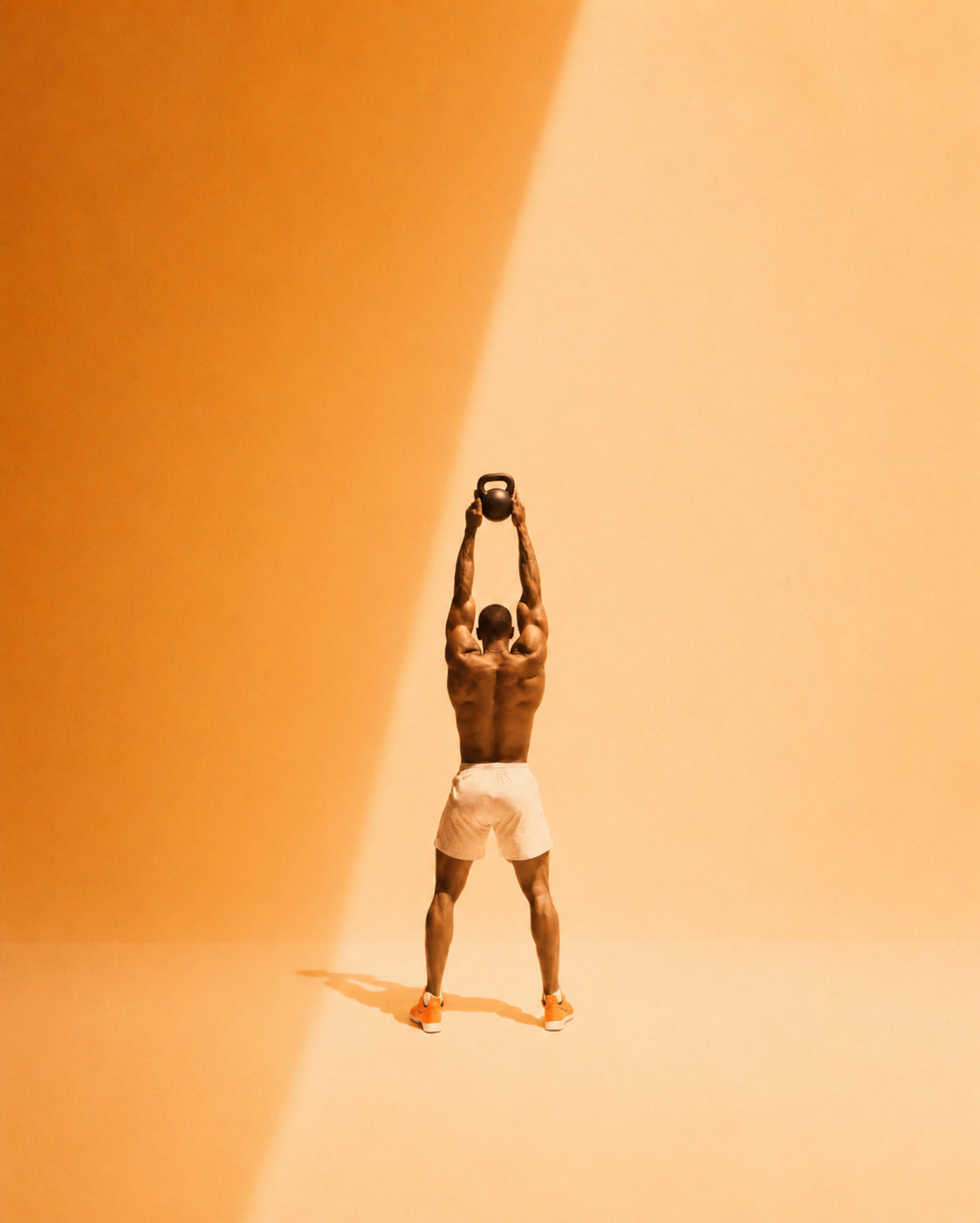 Kettlebell at the top of a swing, athlete braced, hard side light